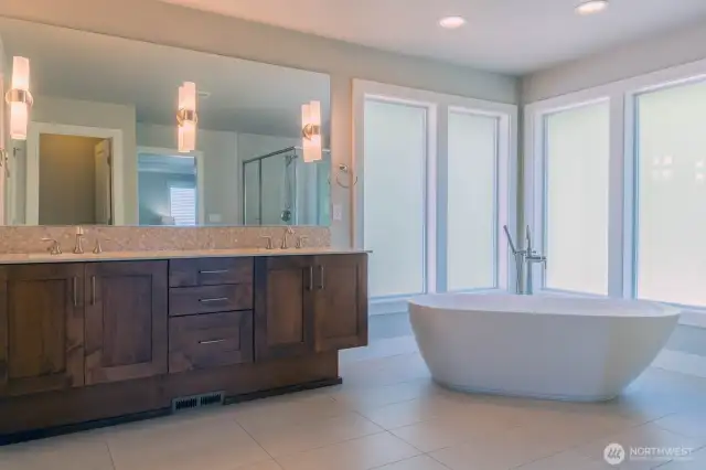 Soaking tub in the light filled primary bathhroom