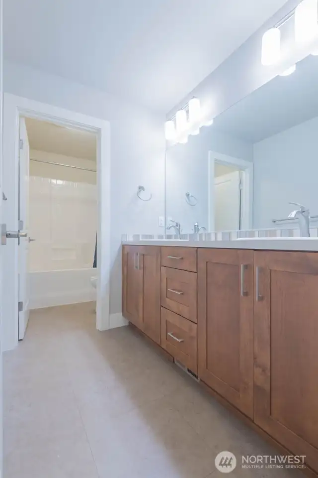 Upstairs hall bathroom  features double sinks