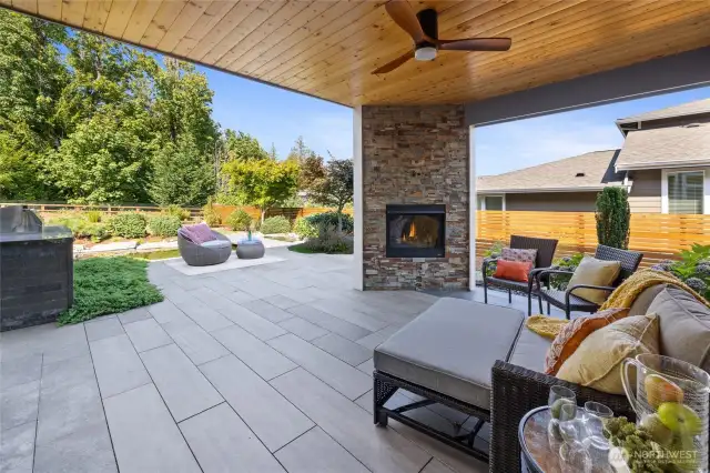 Beautirful covered patio with gas fireplace, lighting and fan for comfortable relaxing and year round entertaining