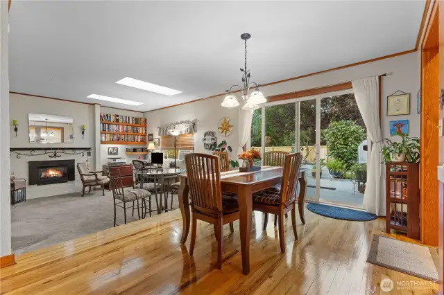 Dining room with refinished original hardwood floors. Slider to large deck.