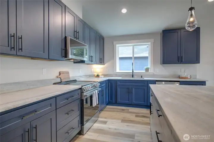 Navy and white washed cabinets with gorgeous leather finish quartz counters