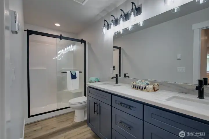 Primary bathroom with double sinks and shower
