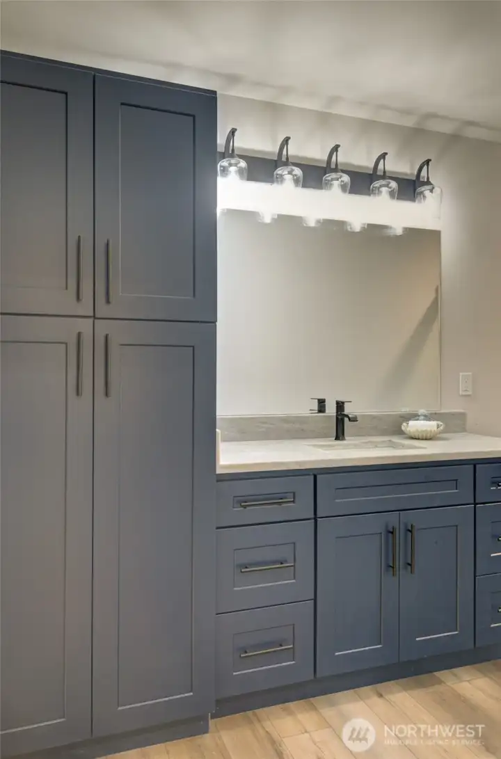 Main bath has lots of storage, including a linen closet