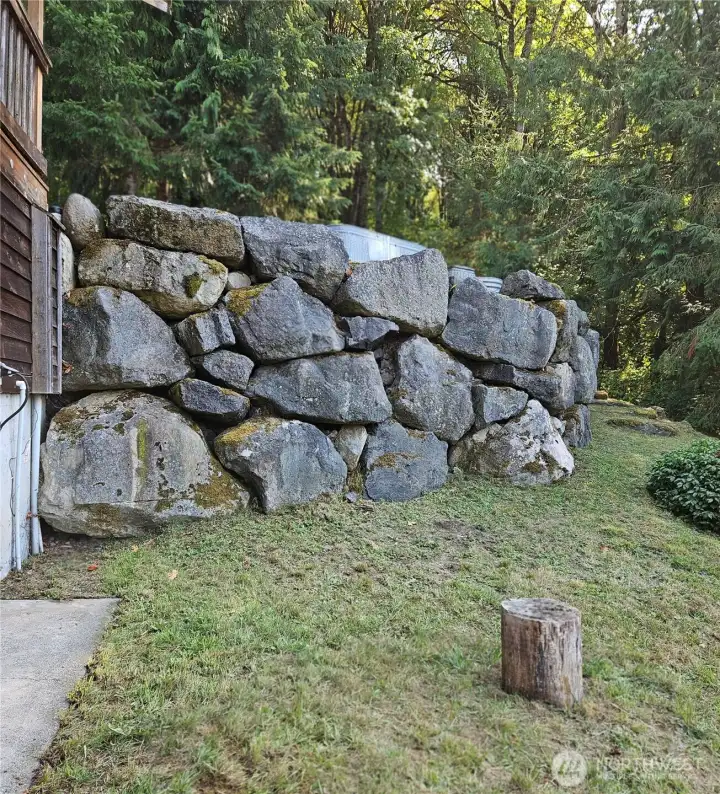 Rock wall by barn and driveway