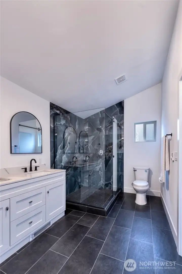 Perfect blend of design style and function in primary with walk-in closet entry at opposite end.