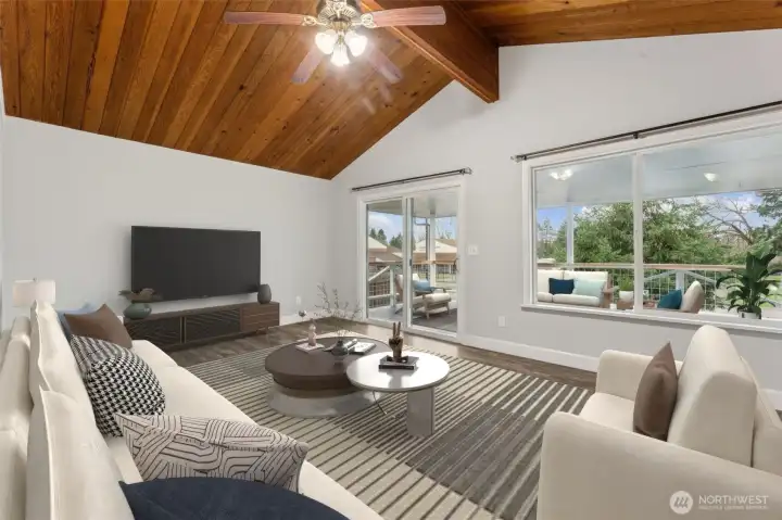 *Virtually staged- Living room and patio door leading out to covered balcony. Beautiful cathedral ceilings! Second kitchen is just behind the living room with an open concept.  Part of split-level portion of house.