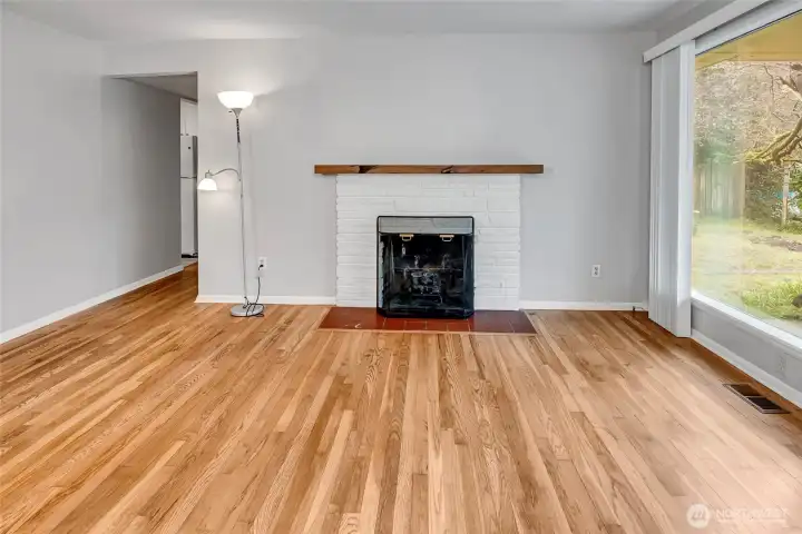 Fire place in the living room. Hallway leading to the bedrooms and bath.