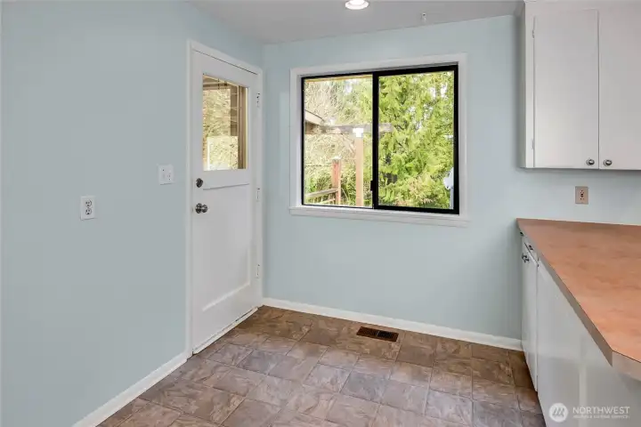 From the kitchen dining space the door heads out to the covered patio and backyard.