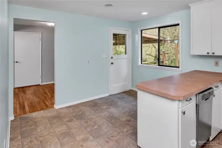 Looking through the threshold towards the dining room from the kitchen.