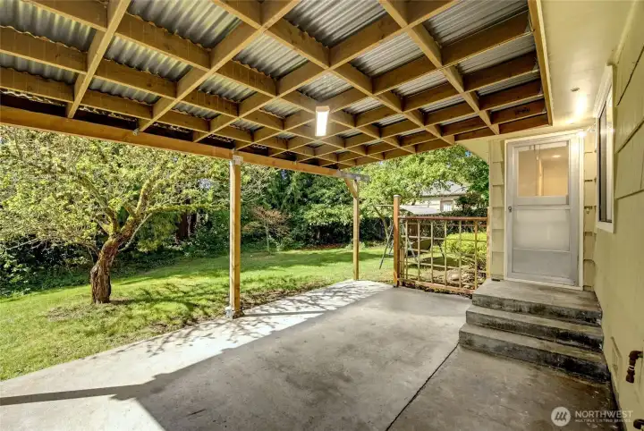 Covered rear patio provides dry space outdoor gatherings.