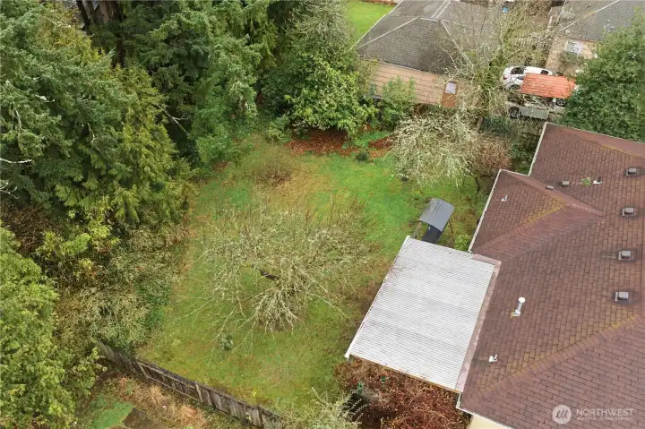 Another angle of the backyard and wooded area on this lot that nicely screens from the properties beyond.