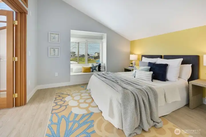 Spacious primary bedroom w/ doors to walk-in closet