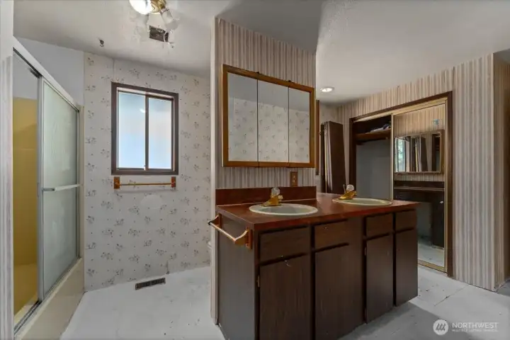 Full bathroom with extra closet space.