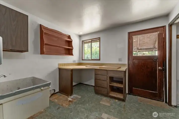 Utility room with backdoor.