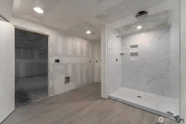 Partially finished bathroom. New tiled shower.