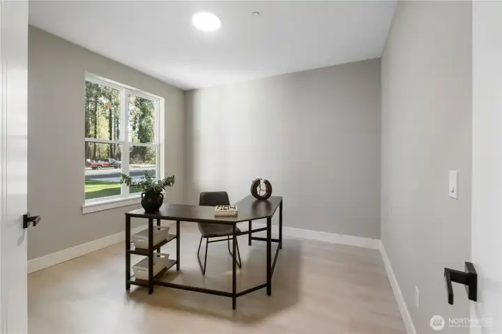 Large windows fill the home office/den w/natural light