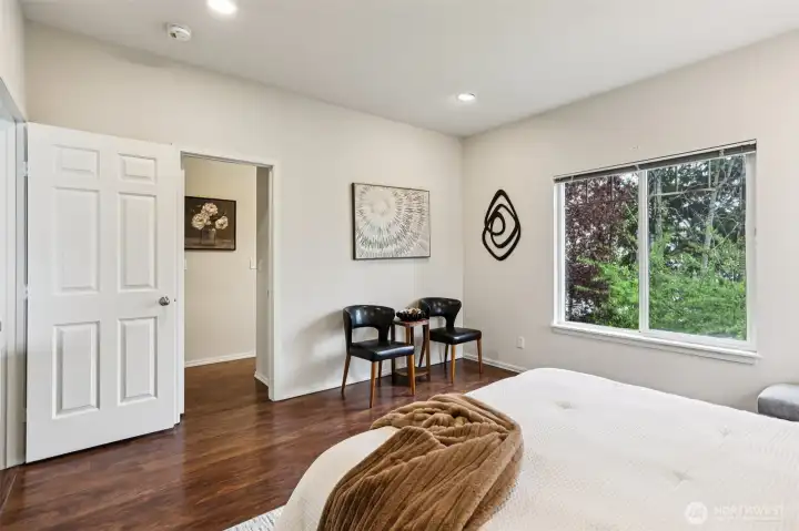 Comfortable primary suite with warm flooring, clean lines, and a calm, inviting feel—designed for everyday relaxation.