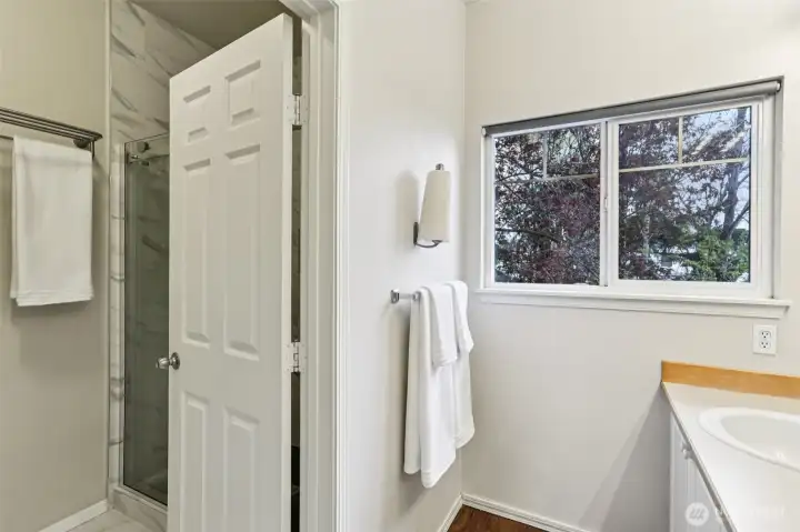 Clean, updated bathroom featuring a sleek tile shower and simple, functional layout for everyday ease.