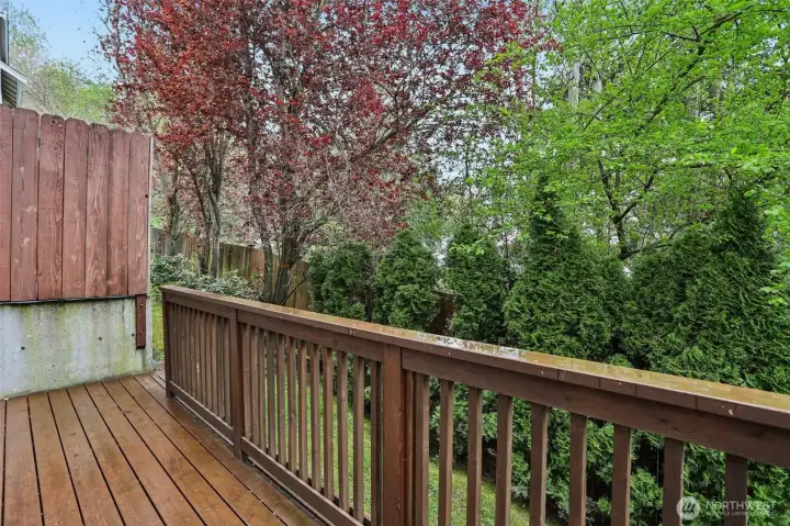 Private deck surrounded by greenery, perfect for relaxing or outdoor dining