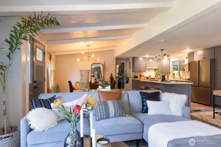 Living room with full view of dining room, kitchen and den