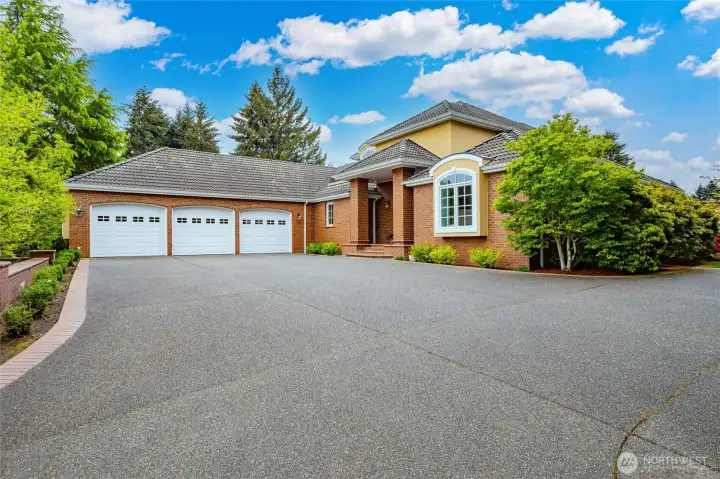 Welcome home!  The Large Driveway leads to 3 bay garage, with extra parking on side of house.