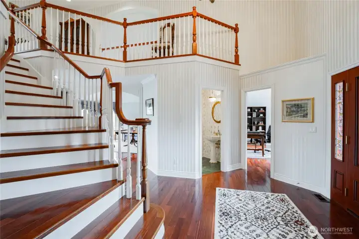 Beautiful cherry wood flooring leads you up the stairs.
