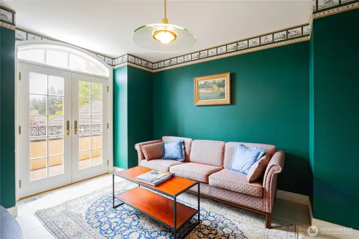 Bonus room upstairs, French doors leading to a balcony.