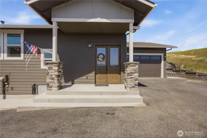 Oversized 2-car garage with workshop space, loft storage, dual entry access, and 28-foot depth ideal for hobbies, storage, or additional workspace.