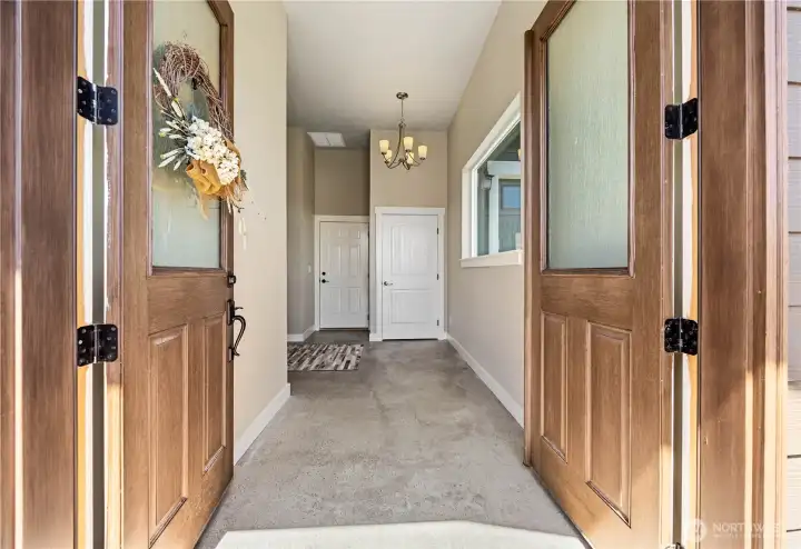 Welcoming entry with vaulted ceilings, real oak hardwood floors, and natural light creating a warm first impression the moment you step inside.