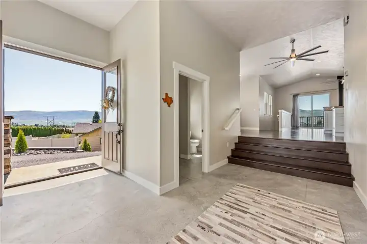 Welcoming entry with vaulted ceilings, real oak hardwood floors, and natural light creating a warm first impression the moment you step inside.