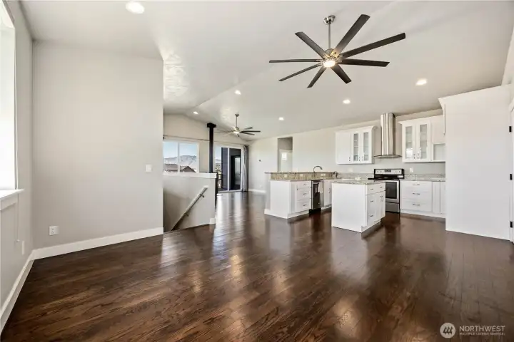 Dining area with warm hardwood floors, open layout, and picturesque hillside and valley views perfect for entertaining.