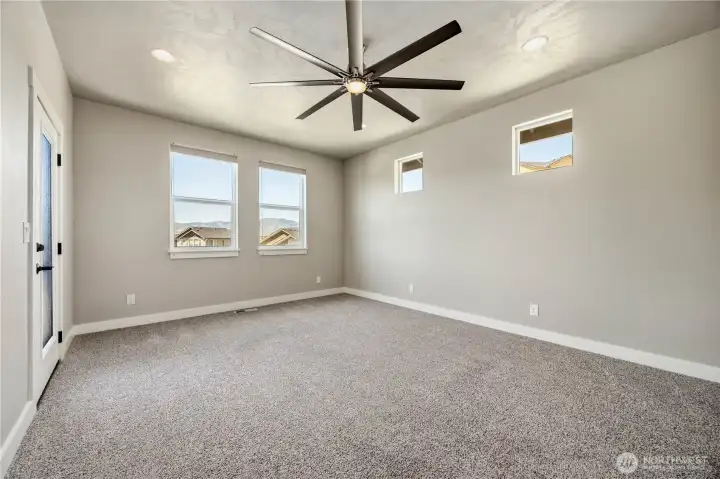 Luxury primary suite with soundproof wall, scenic views, and flexible bonus room access for office or nursery space.