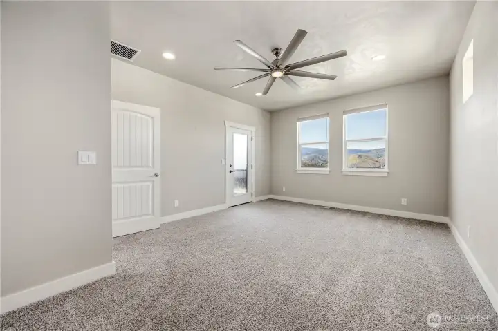 Luxury primary suite with soundproof wall, scenic views, and flexible bonus room access for office or nursery space.