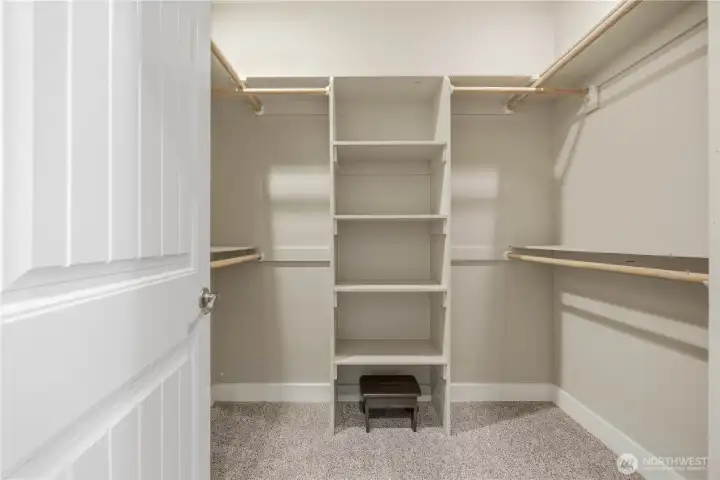 Oversized primary closet with built-in organization and abundant storage space.