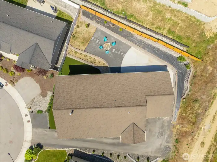 Stunning aerial perspective showcasing the home’s elevated hillside setting, wraparound Trex decking, beautifully designed outdoor spaces, and sweeping 180-degree valley views.