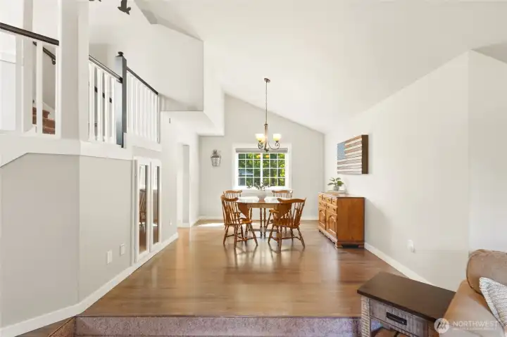 Open formal dining area with natural light and seamless flow into kitchen and living spaces, ideal for entertaining.