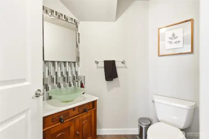 Updated main-level bathroom with modern finishes and clean design for guest convenience.