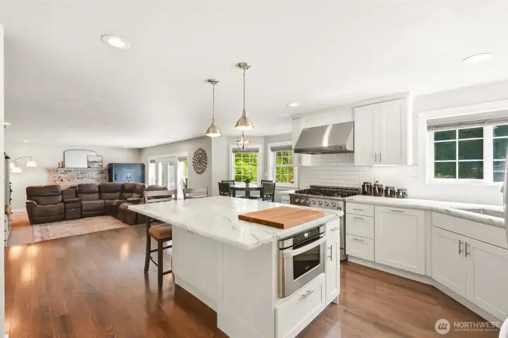 Large kitchen with center island, ample cabinetry, and open-concept flow perfect for gatherings and daily living.