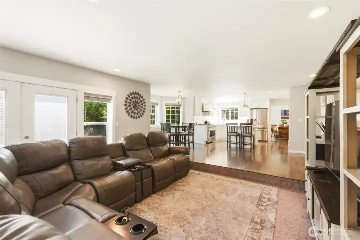 Expansive living room with open layout, natural light, and comfortable gathering space for guests.