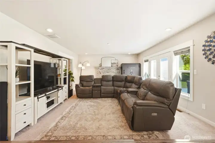 Large living room with flexible layout, perfect for movie nights, entertaining, or additional living space.