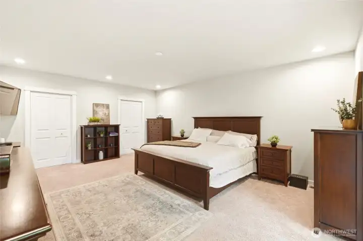 Spacious main level primary suite with generous layout, natural light, and a separate exterior entry