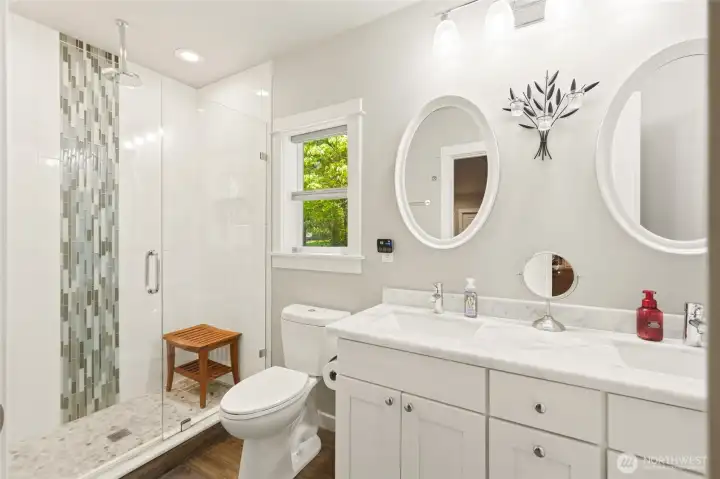 Main level Primary bathroom with dual vanities, updated finishes, and functional design for everyday comfort.