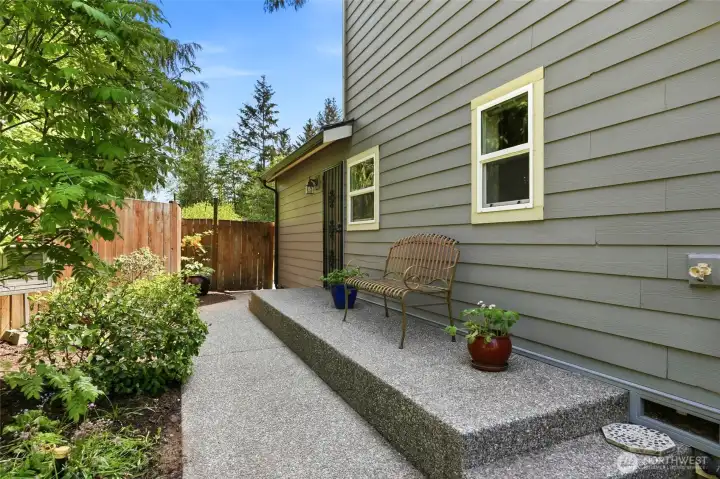 Side yard access with clean landscaping and easy flow to backyard outdoor living areas and main level primary.
