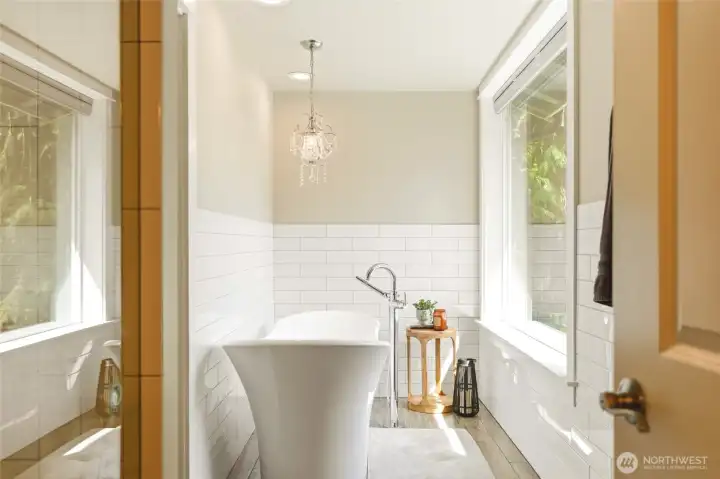 Spa-like bathroom off 2nd primary bedroom with soaking tub and serene natural light, creating a relaxing retreat atmosphere.