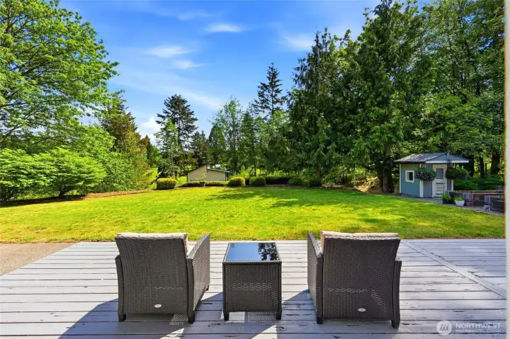 Outdoor entertaining space with large deck and open yard, perfect for gatherings and enjoying Enumclaw lifestyle.