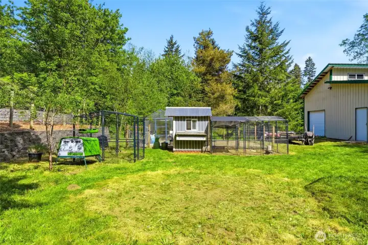 Additional yard space with outbuilding and open lawn, offering flexibility for storage, hobbies, or outdoor use.