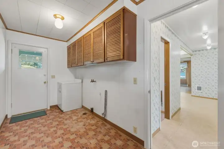 Laundry room with door to back