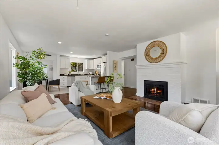 Step into the open concept living space, with a wood burning fireplace.