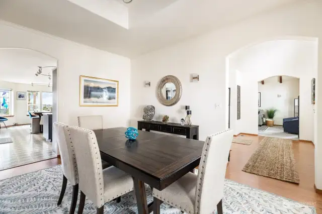 The dining sits to the left of the entry and provides an intimate setting. Just off the kitchen, you'll fall in love with space...coffered ceilings, pretty lighting, and a bay window that offers up pretty views and nice light.