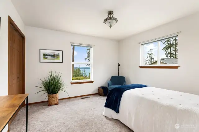 The first bedroom to the left takes in water and mountain views.